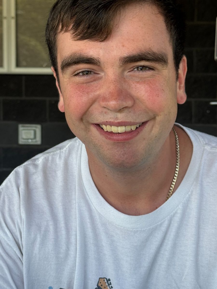 A young man smiling at the camera